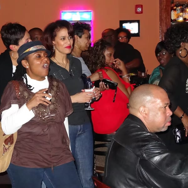 Diverse group of patrons socializing and enjoying drinks at Chicago Bar & Grill.