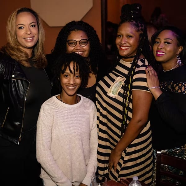 Five smiling women posing together at Chicago Bar & Grill, enjoying a night out.