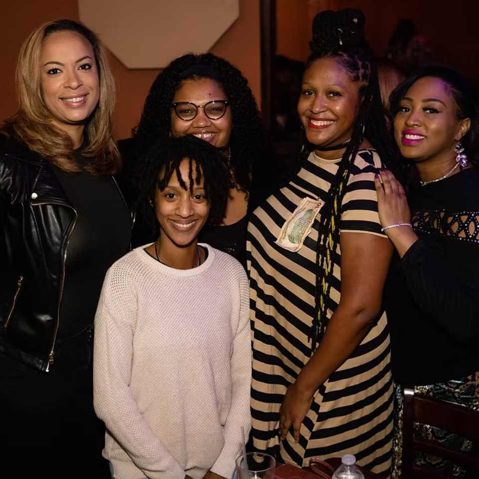 Five smiling women posing together at Chicago Bar & Grill, enjoying a night out.